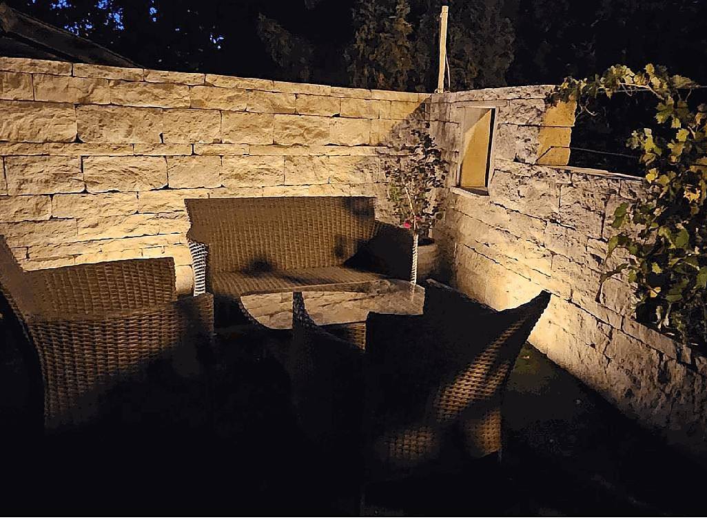 Garten mit beleuchteter Natursteinmauer